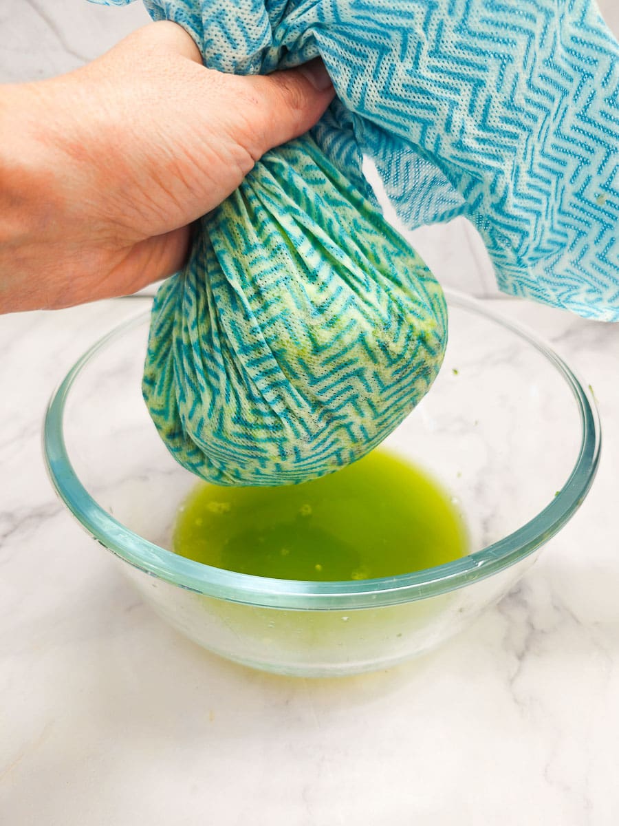 squeezing excess moisture from zucchini with cloth