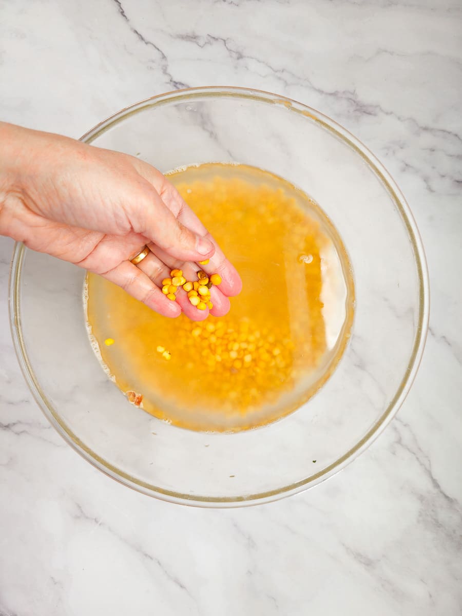 rinsing yellow split peas in a bowl