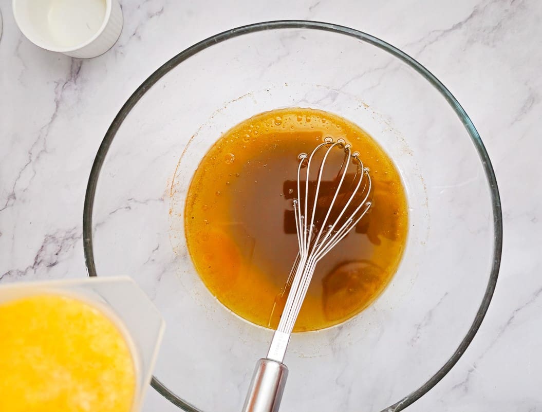 adding orange juice to oil mixture