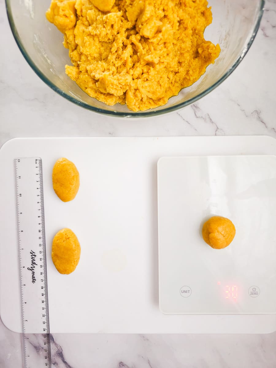 measuring dough for Melomakarona - Greek Honey Cookies