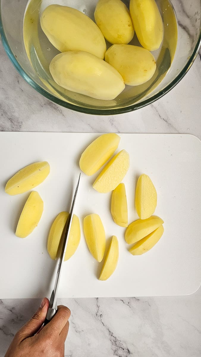 potato wedges on chopping board