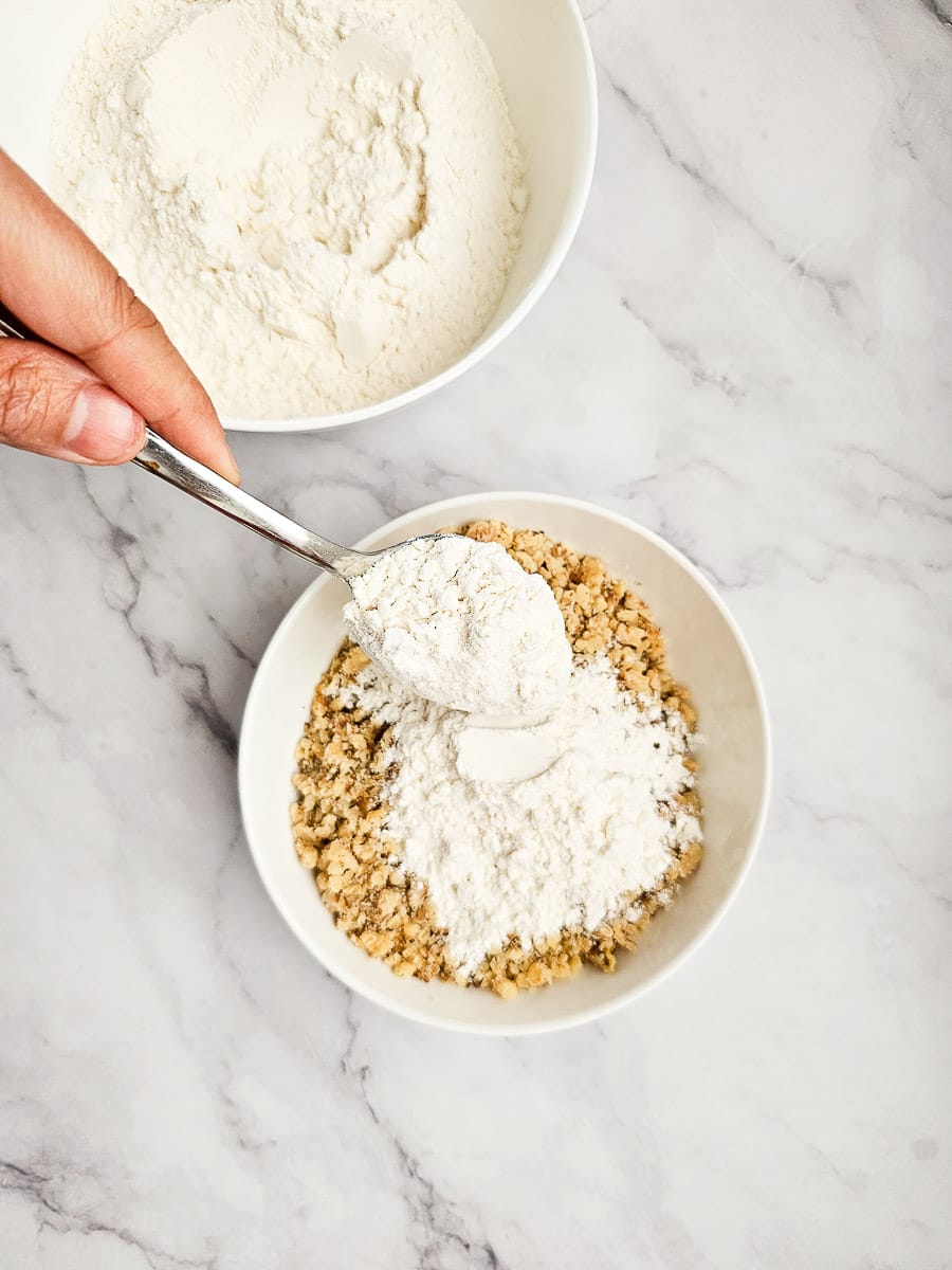 Adding flour to crushed walnuts