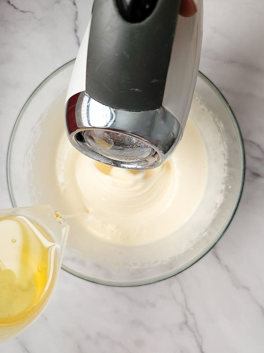 adding oil to egg and sugar mixture