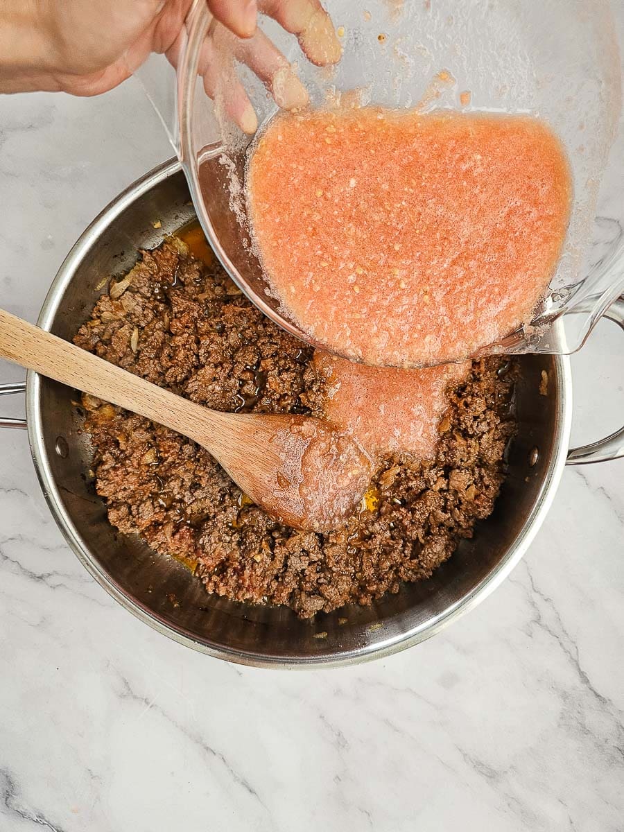 Greek Stuffed Tomatoes with Rice - adding tomatoes to filling