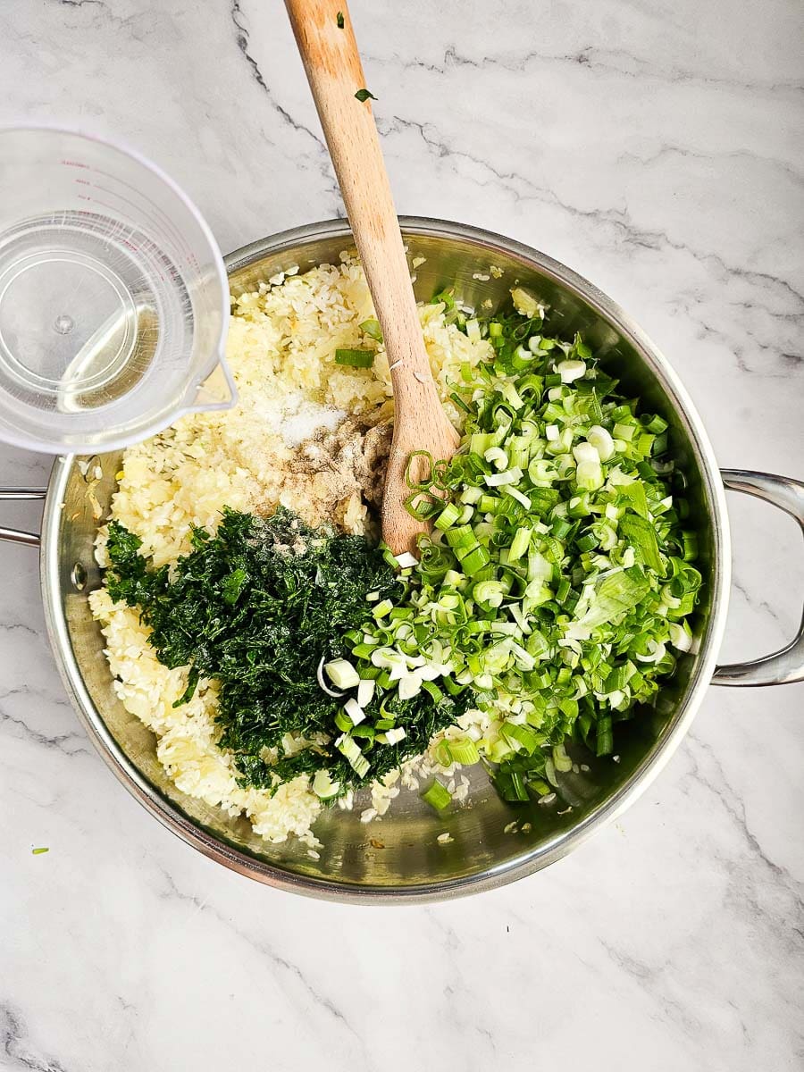 sauteing onions, rice and herbs in saucepan