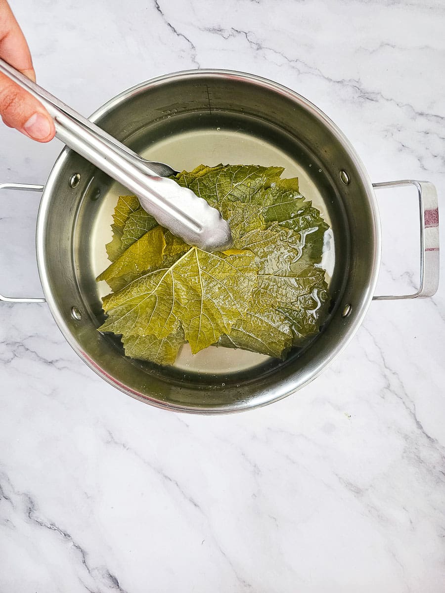 blanching vine leaves in a pot