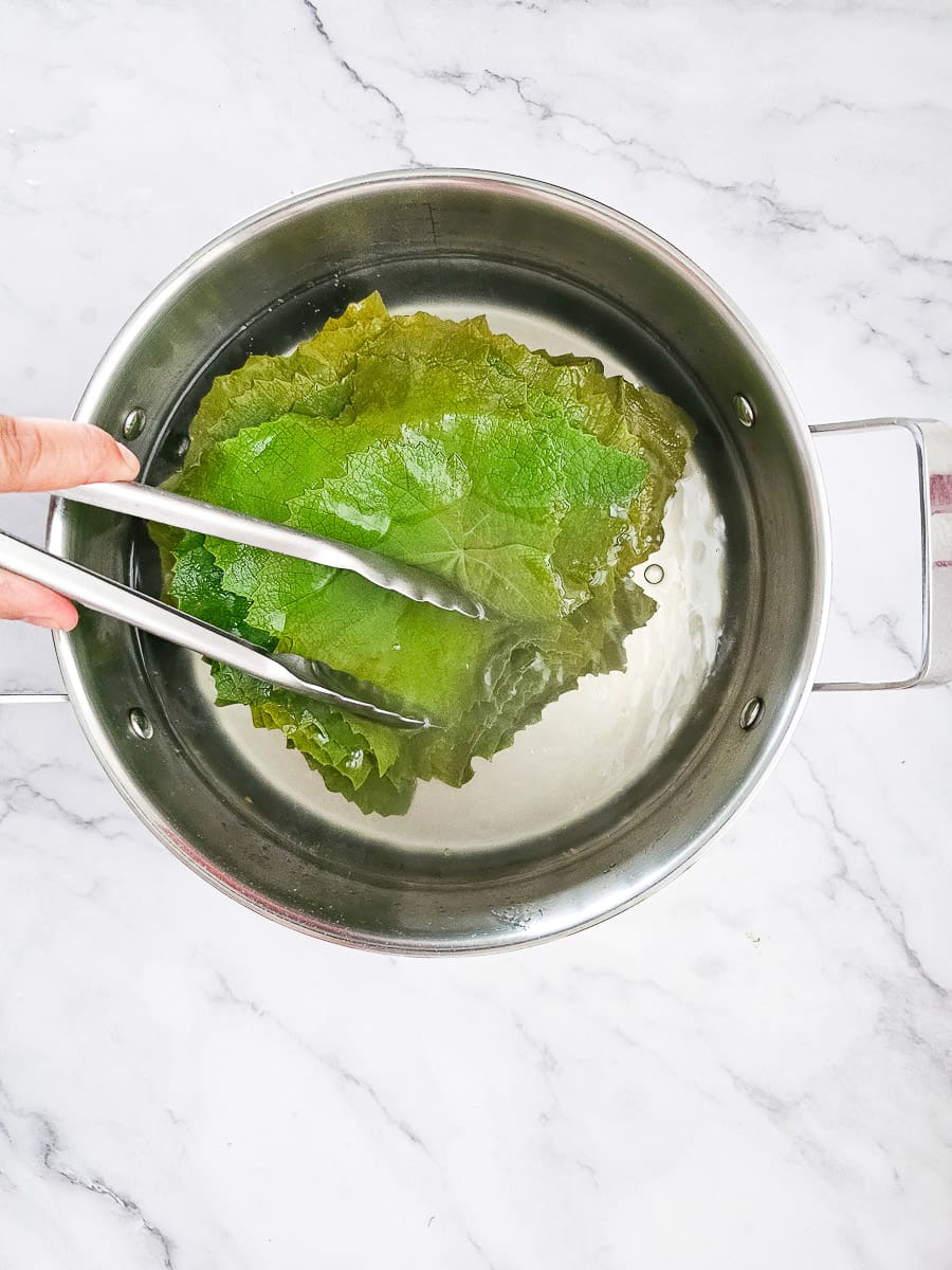 blanching vine leaves in a pot