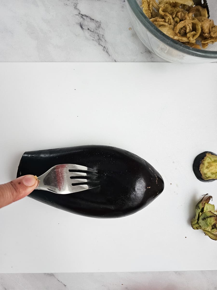 preparing eggplant for Yemista - Greek Stuffed Tomatoes with Rice and meat
