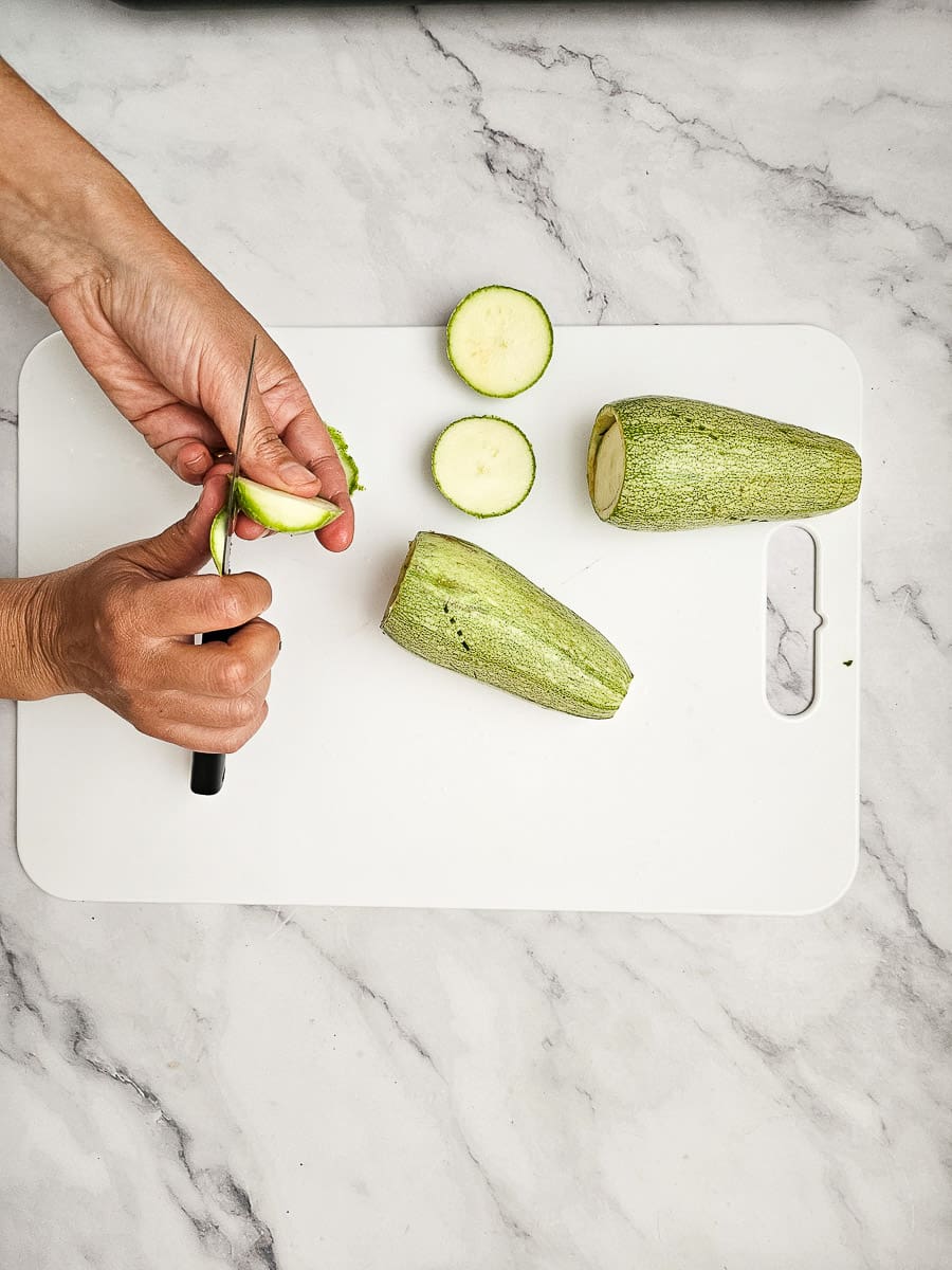 preparing zucchini Yemista - Greek Stuffed Tomatoes with Rice and meat