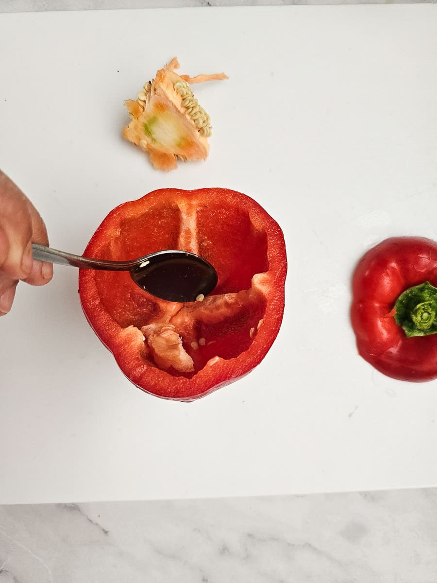 preparing capsicum Yemista - Greek Stuffed Tomatoes with Rice and meat