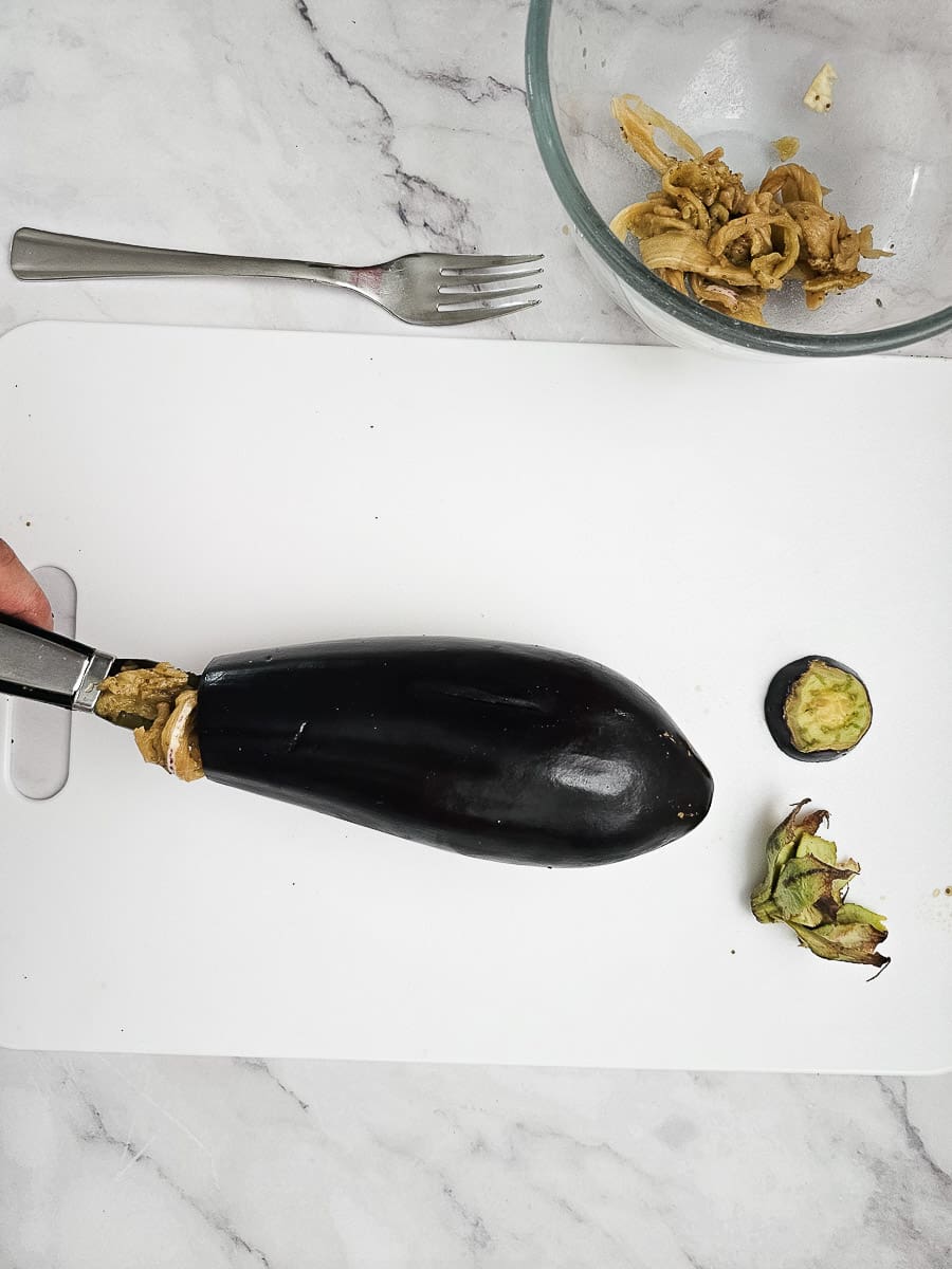 preparing eggplant for Yemista - Greek Stuffed Tomatoes with Rice and meat