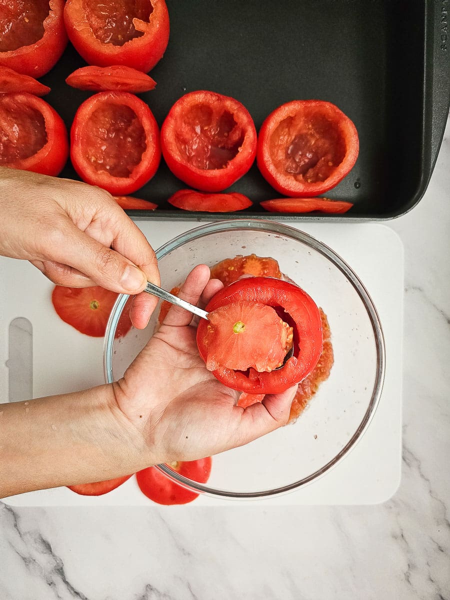 preparing tomatoes for Yemista - Greek Stuffed Tomatoes with Rice and meat