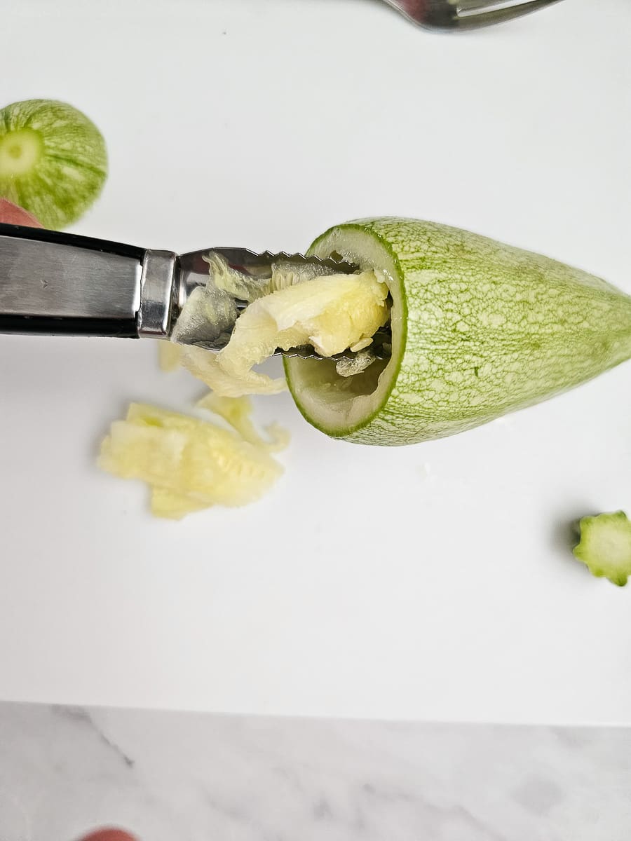 preparing zucchini for Yemista - Greek Stuffed Tomatoes with Rice and meat