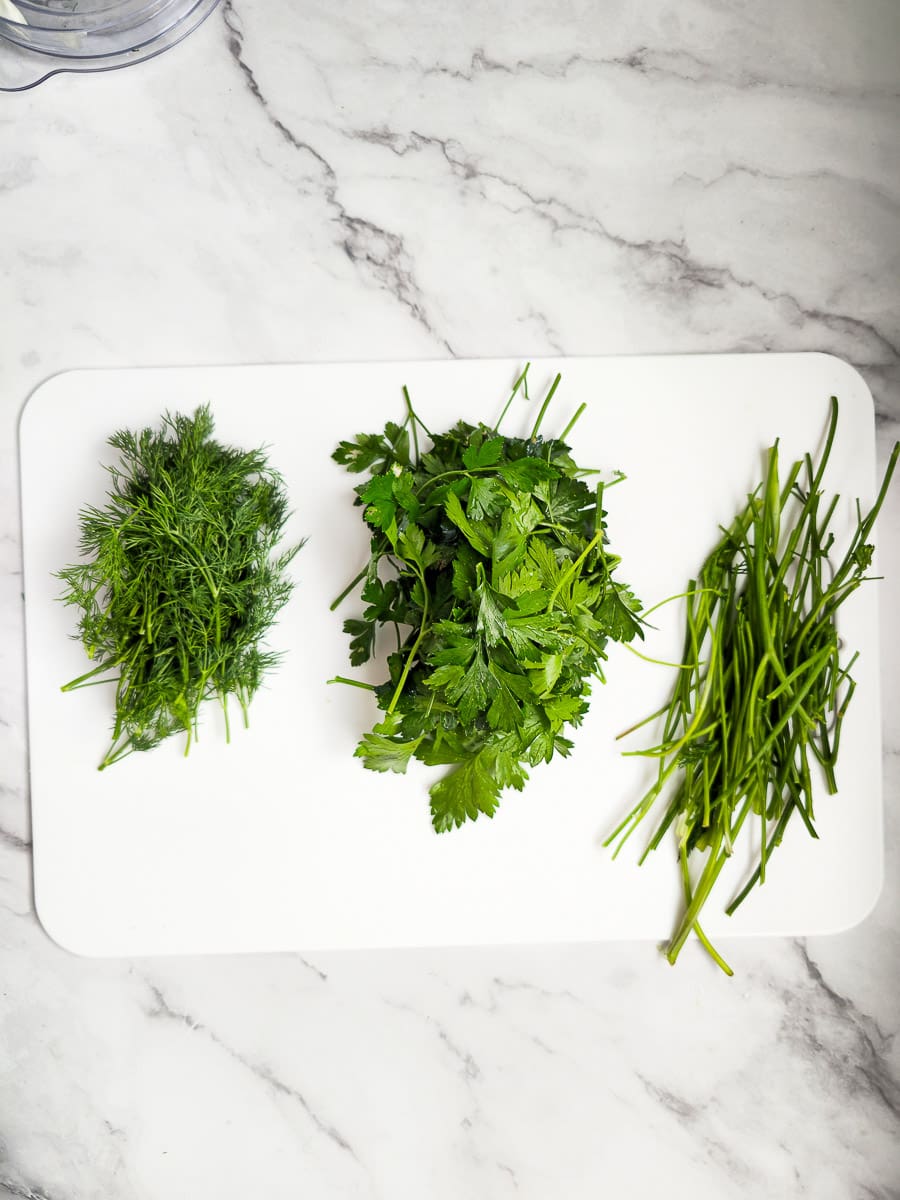 dill and parsley on chopping board