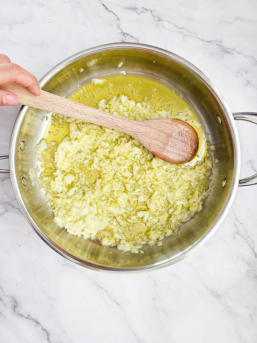 sauteing onion in frying pan