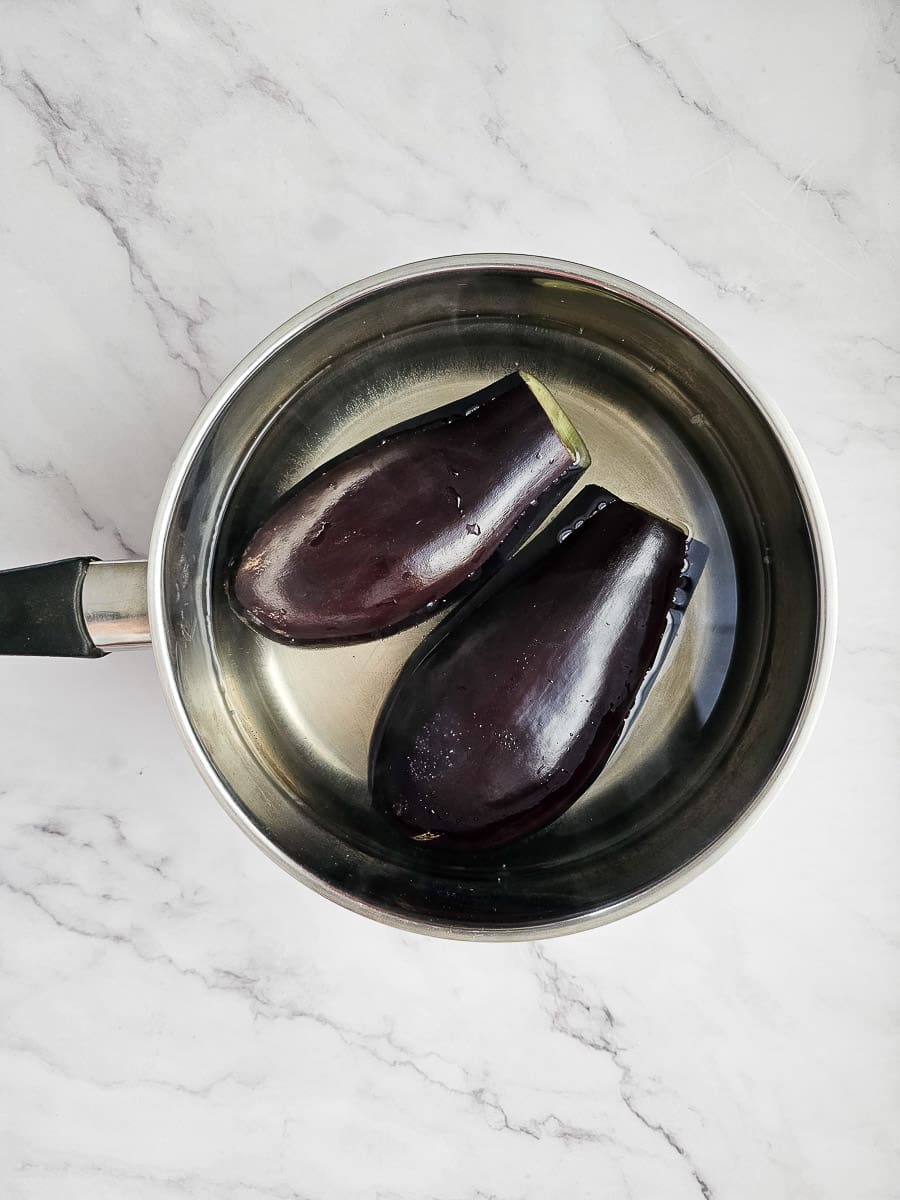 preparing eggplant for Yemista - Greek Stuffed Tomatoes with Rice and meat