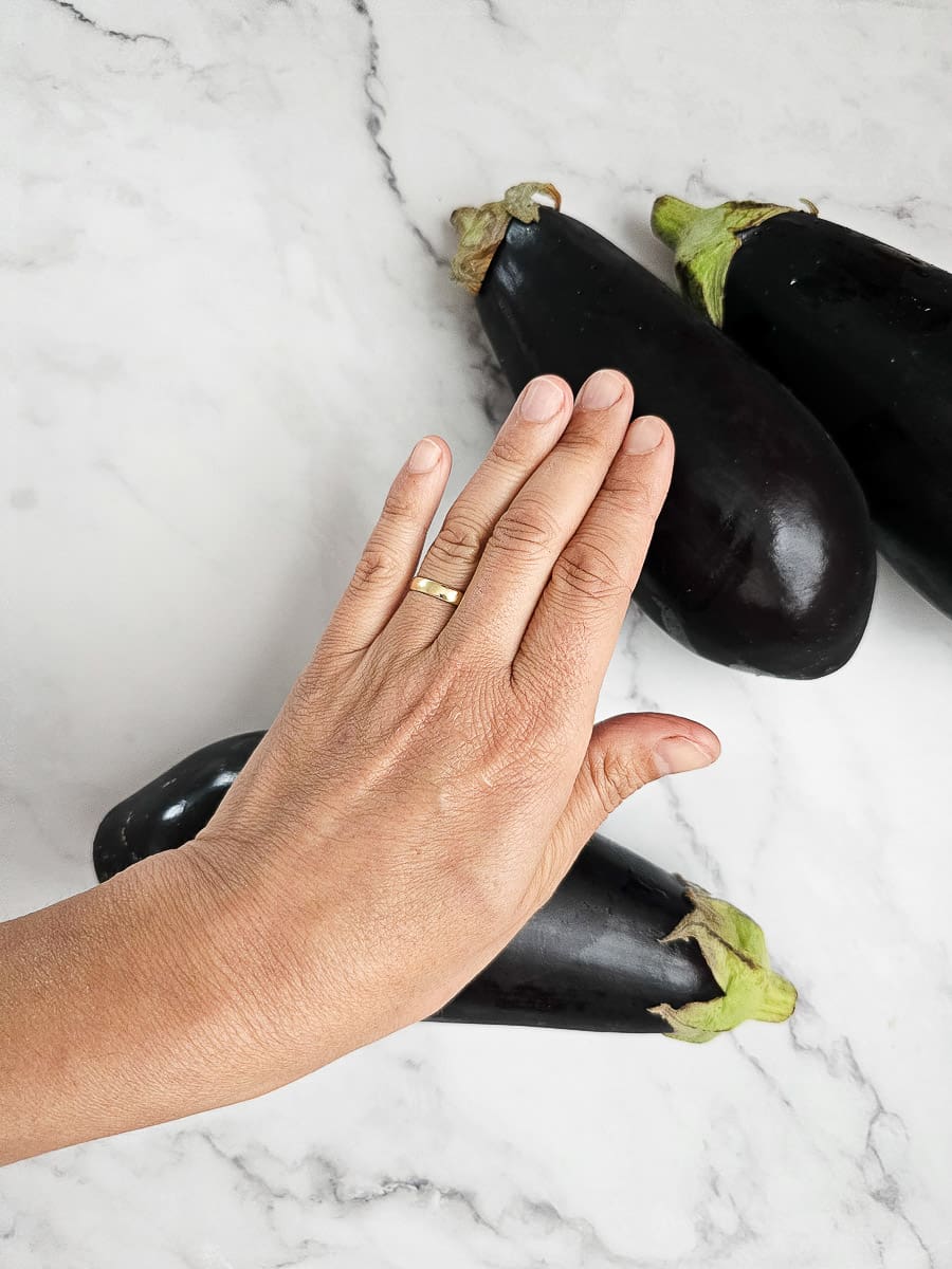 preparing eggplant for Yemista - Greek Stuffed Tomatoes with Rice and meat