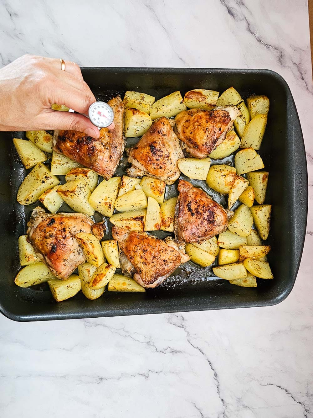 Greek Lemon Roasted Chicken and Potatoes in a baking tray
