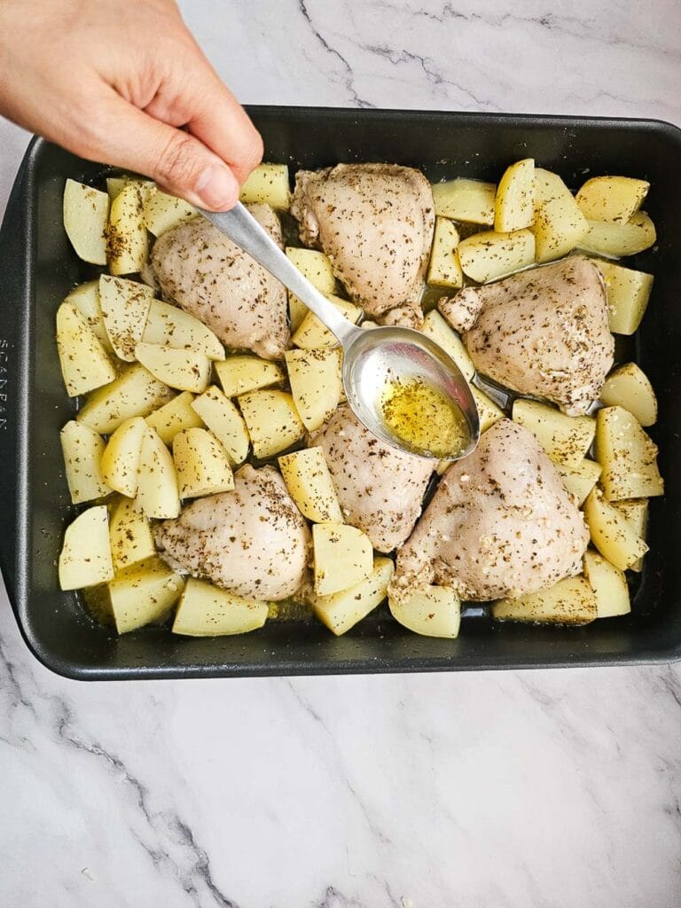 Greek Lemon Roasted Chicken and Potatoes in a baking tray