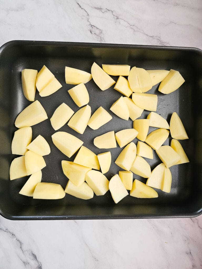 potato wedges in baking tray before baking