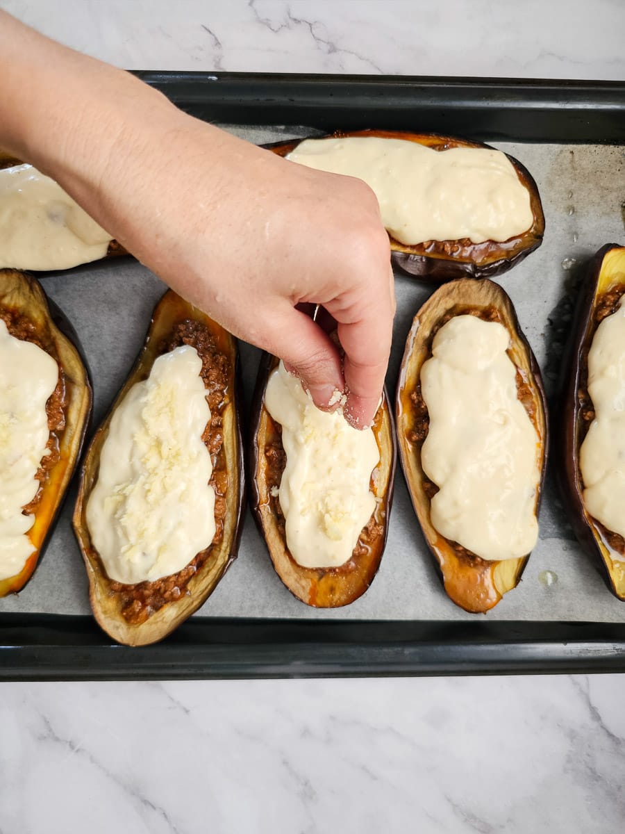 papoutsakia greek stuffed eggplant adding cheese