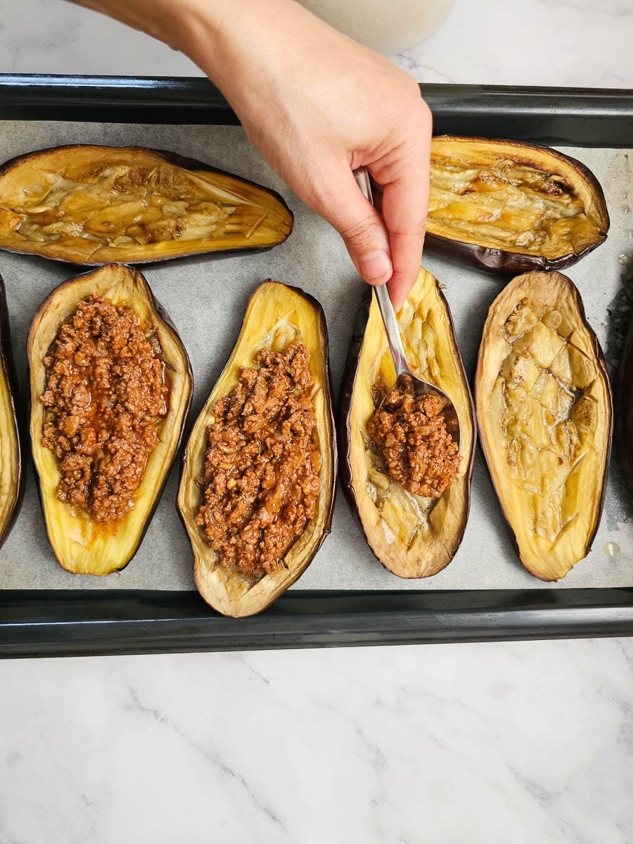 papoutsakia greek stuffed eggplant adding mince