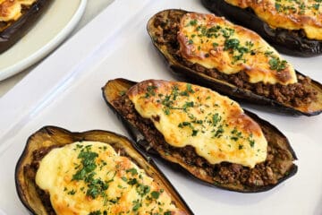 Papoutsakia - Greek stuffed eggplant- on a plate.