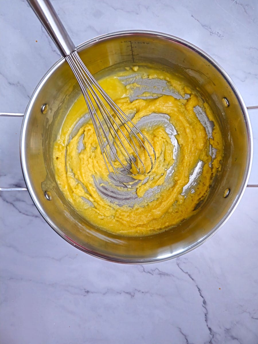 adding flour to melted butter in pot