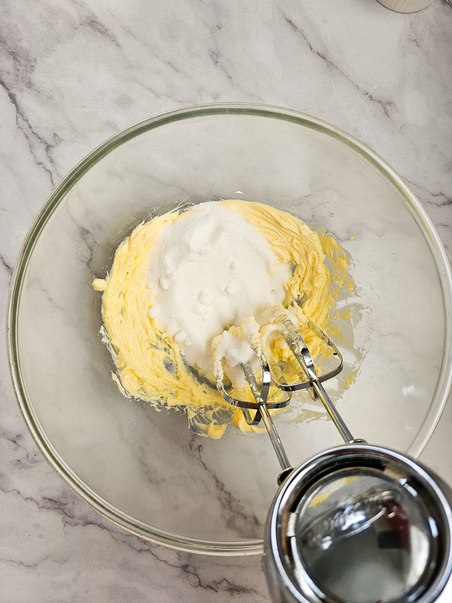 cream butter and sugar in glass bowl