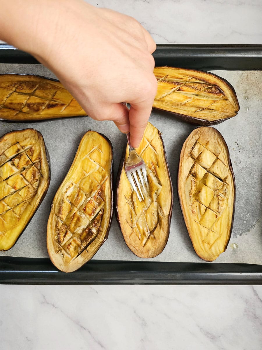 pressing eggplant flesh with fork