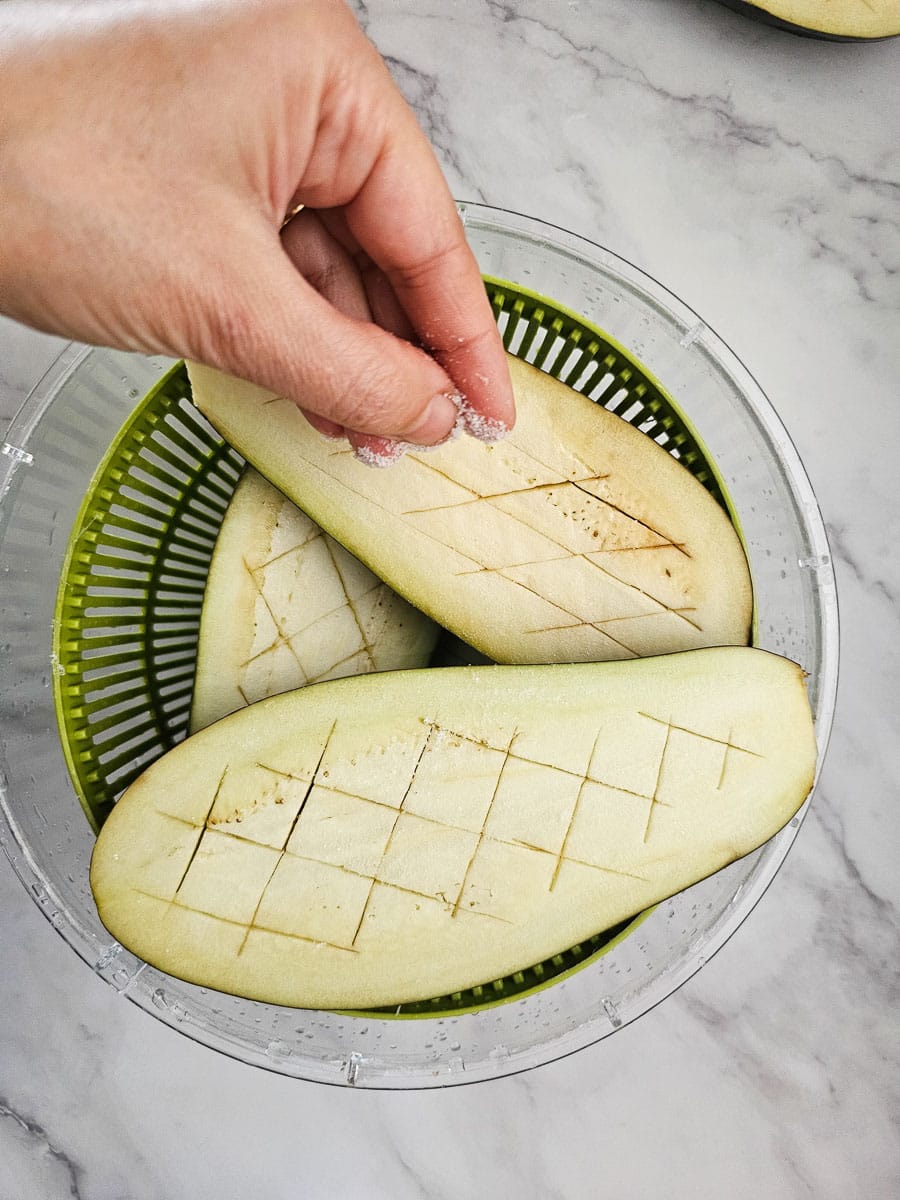salt eggplant in colander