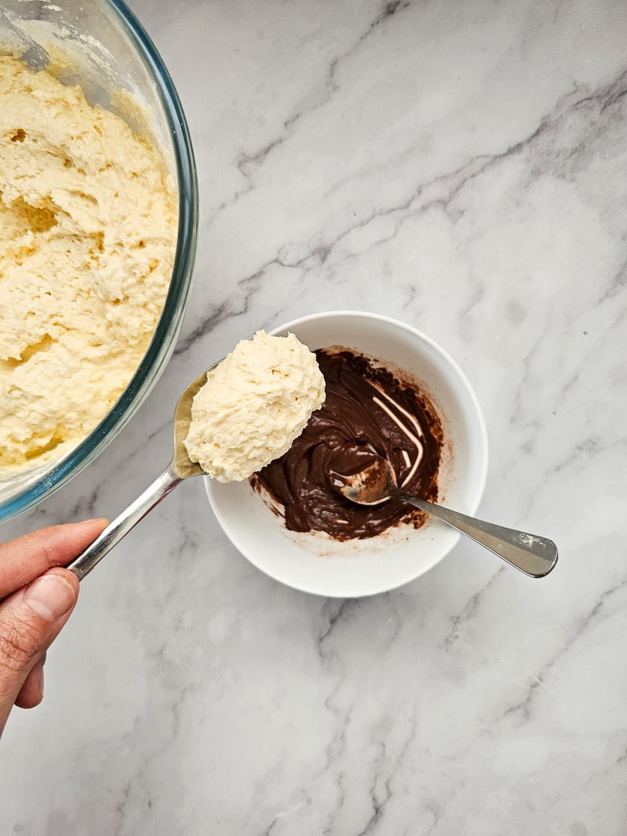 adding cake batter to cocoa